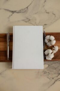 Blank notepad with cotton flowers